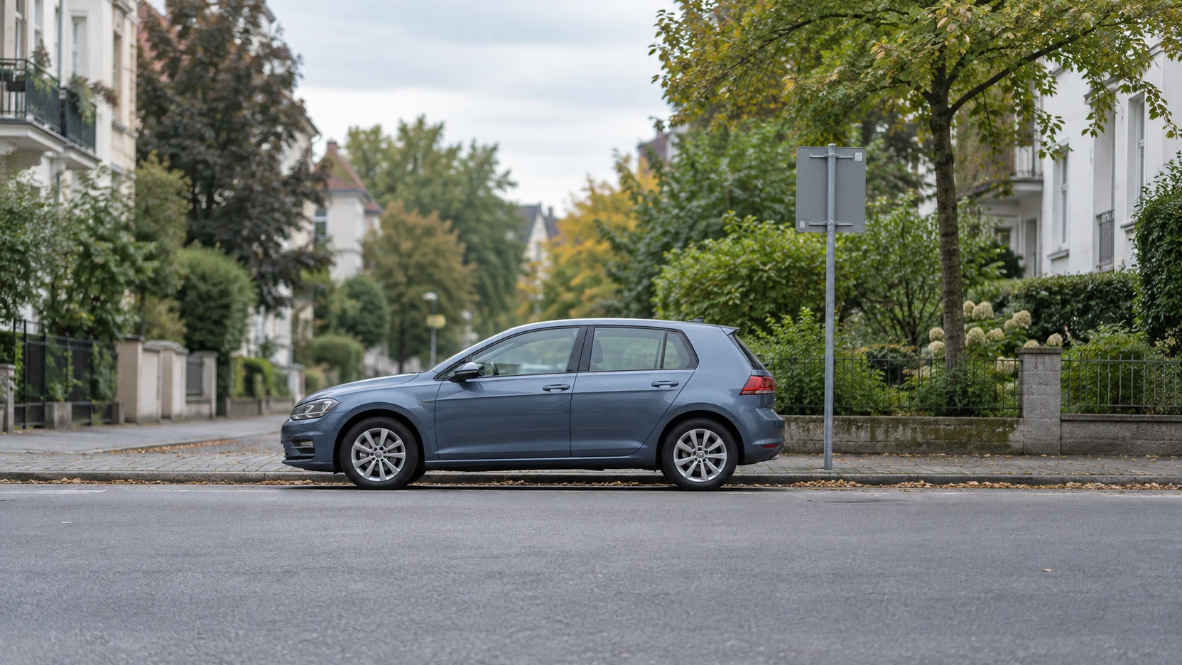 KI-Symbolbild: Blaugraues Auto neben der Rückseite eines Straßenschilds in einer Wohnstraße.
